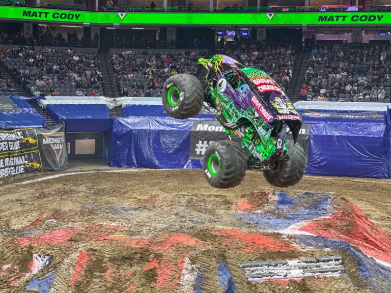 Grave Digger monster truck jumping during Monster Jam at Golden 1 Center in Sacramento.