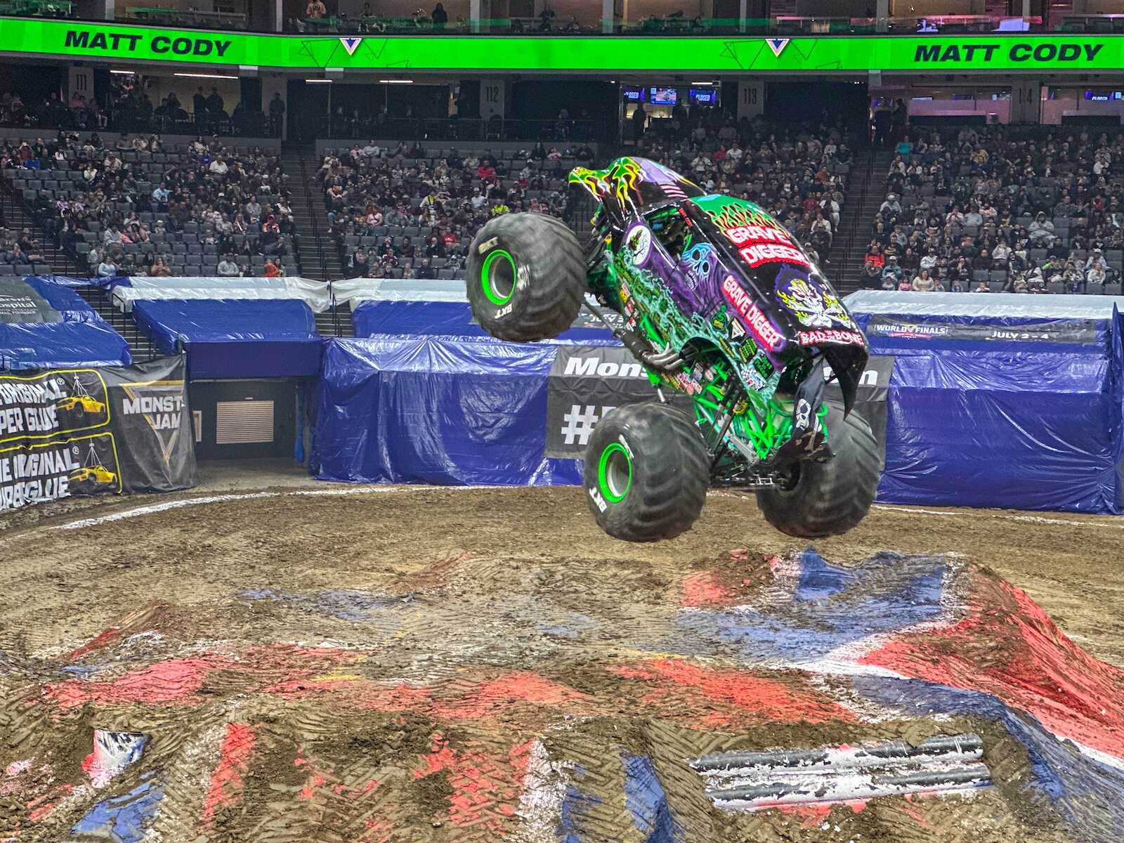 Grave Digger monster truck jumping during Monster Jam at Golden 1 Center in Sacramento.