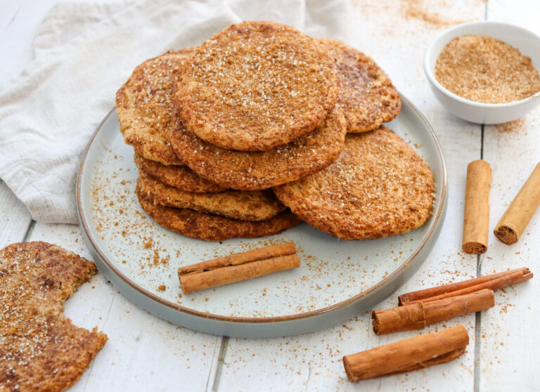 Homemade cinnamon sugar cookies stacked on a serving plate.
