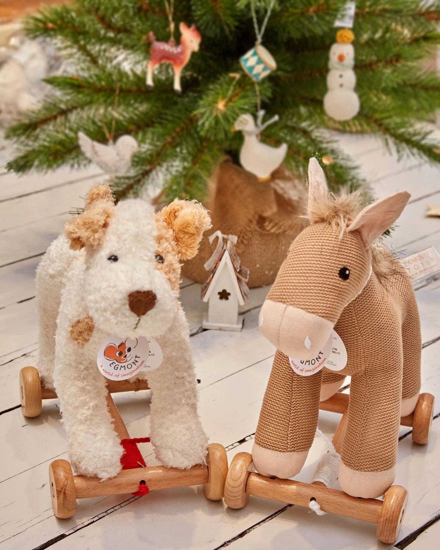 Egmont plush pull-along dog and horse on wooden wheels in front of a Christmas tree